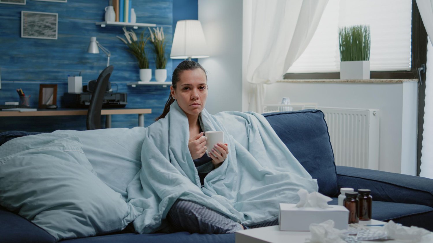Woman recovering from a cold at home